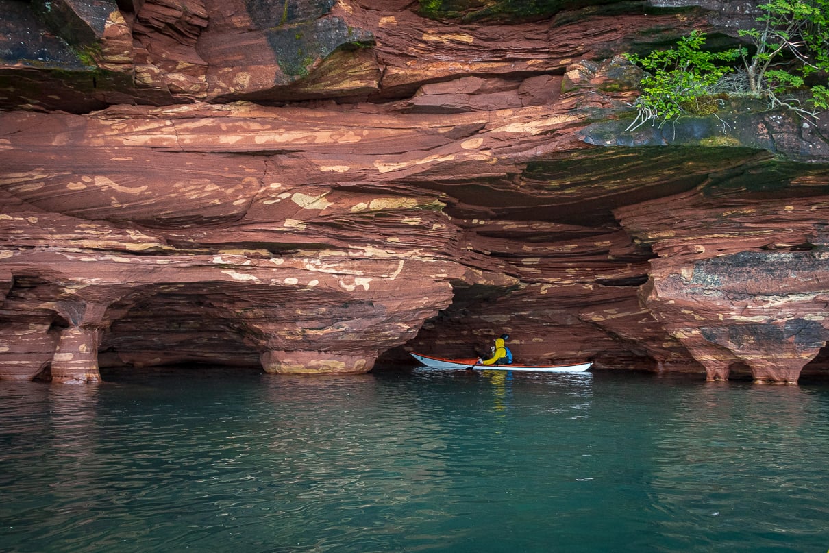 A kayaker explores the sea caves on Sand Island in the Apostle Islands National Lakeshore near Bayfield, Wisconsin. Image: Maddy Marquardt