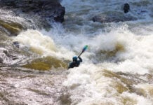 whitewater kayaker paddles through class IV rapid according the ISRD classification system