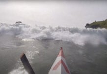 A huge wave barrels at Great Lakes Paddler Tim Gallaway