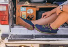 a perosn sits on a tailgate wearing Astral Loyak water shoes
