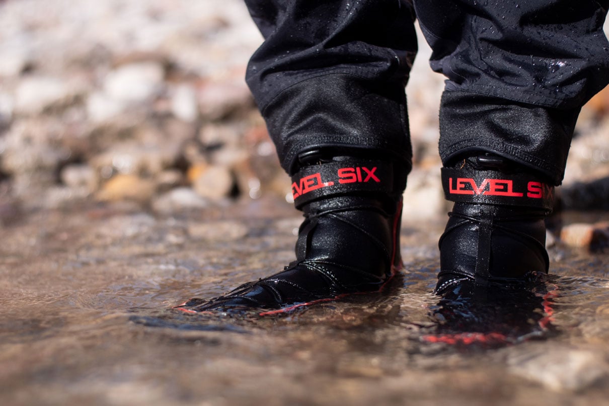 close up of person wearing Level Six Creek Boot 2.0 while standing in water