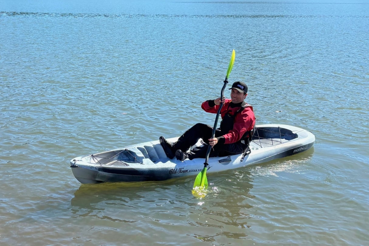 Man with sit-on-top kayak on Lake.