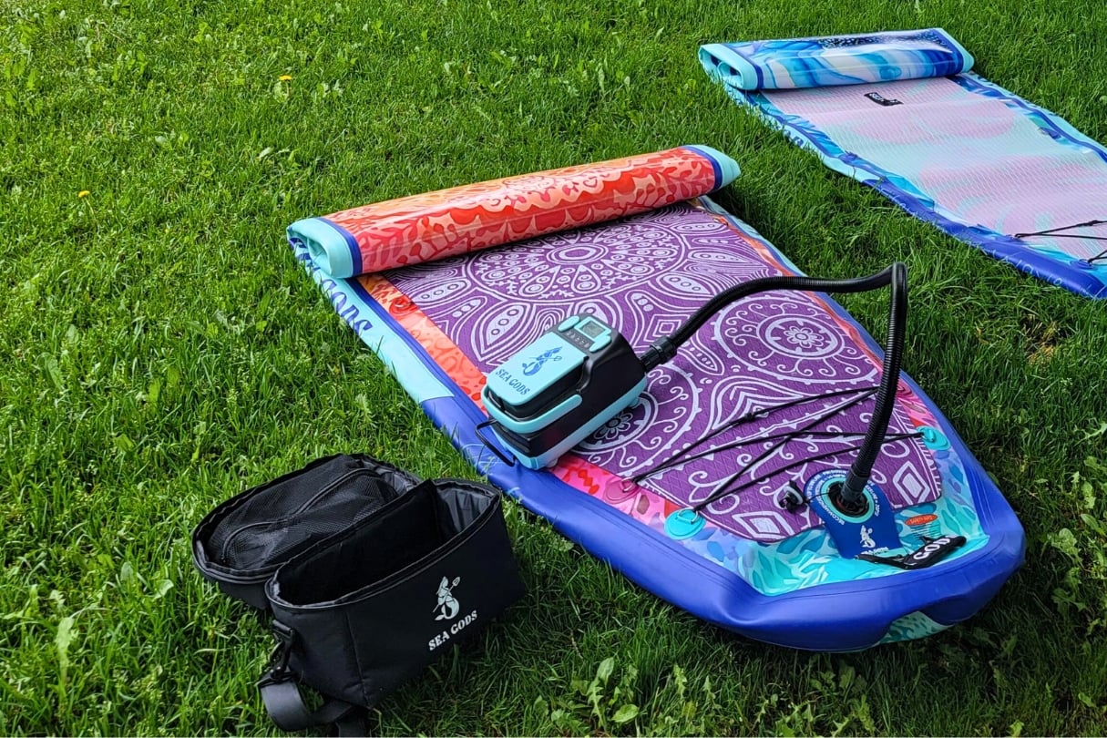 Electric paddleboard pump laying on board.