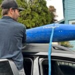 Preparing to transport a kayak without a roof rack.
