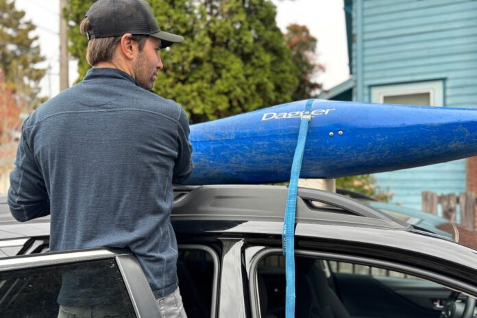 Preparing to transport a kayak without a roof rack.