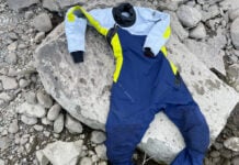 Image of the Helix Women's Drysuit by Mustang Survival on rocks by a river