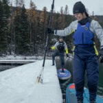 Ice Cold Innovation: How The World’s Leading Cold Water Safety Gear Reaches The Water Woman in Mustang Helix drysuit.