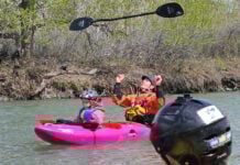 A kid in the front of a tandem kayak at the 3 Rivers Rendezvous
