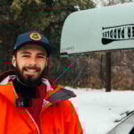 Kyle Parker in front of a canoe