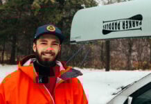 Kyle Parker in front of a canoe